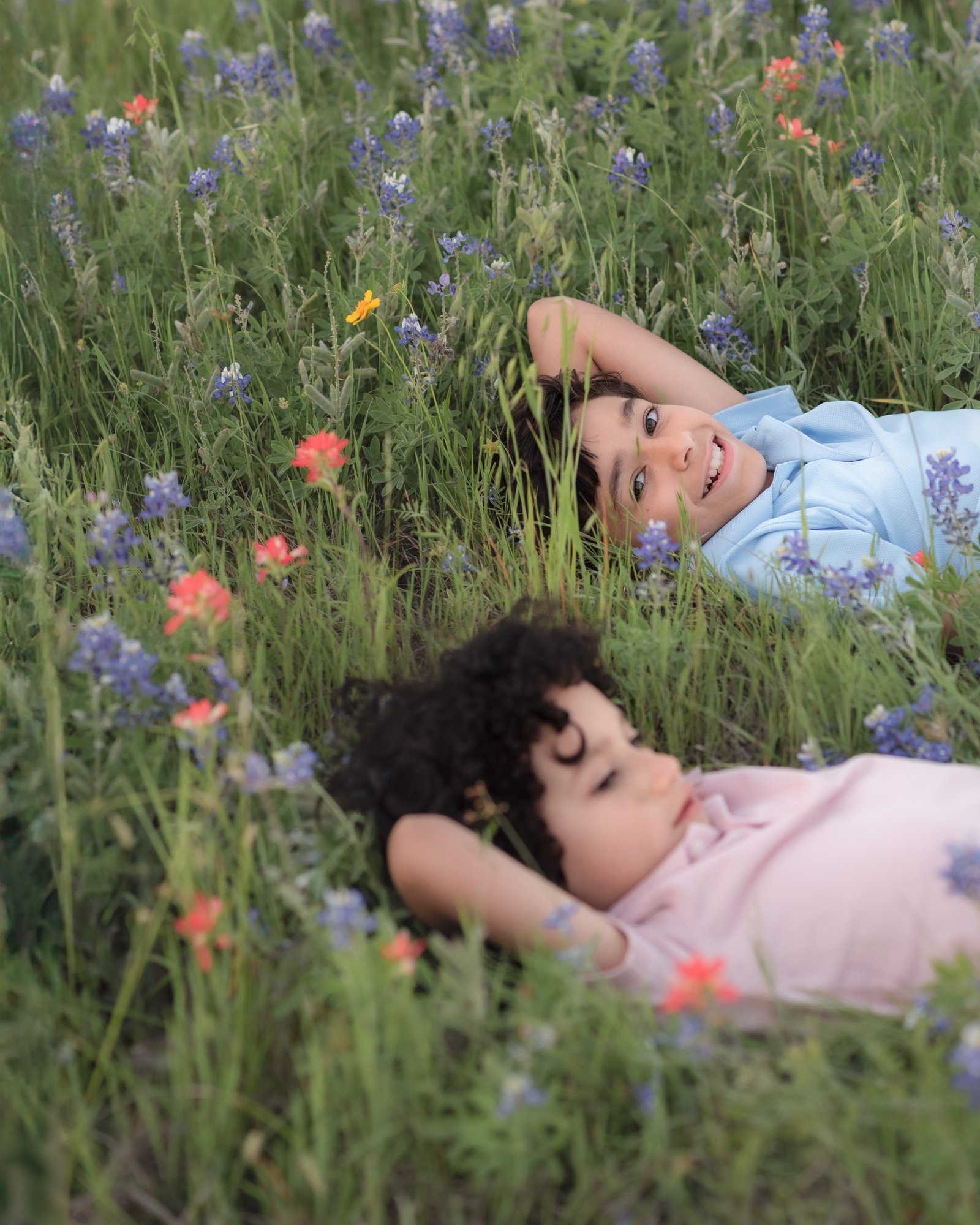 Teresa Vitela spring family session - joyful young siblings enjoying bluebonnet field coordinated outfits College Station Texas