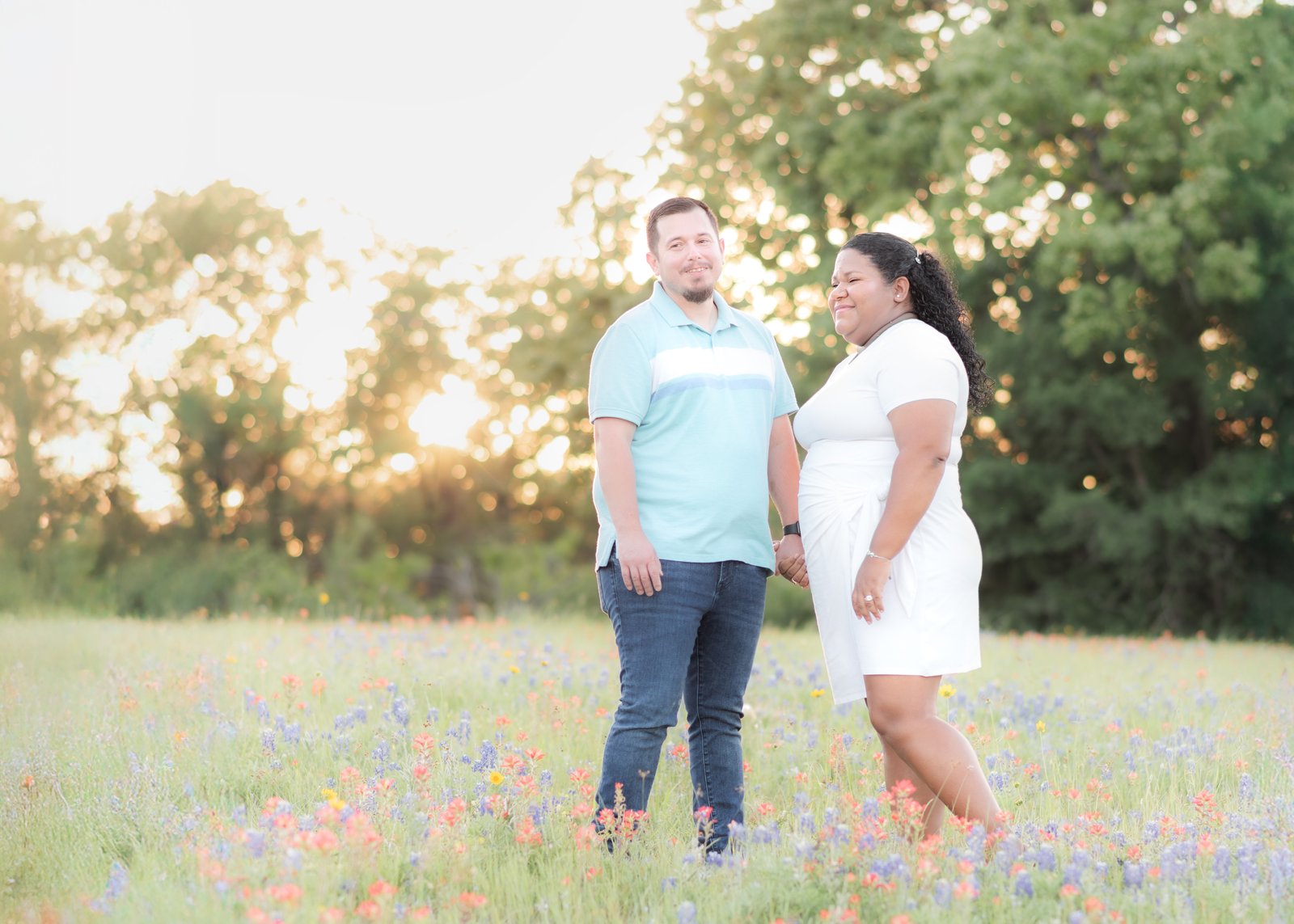 Teresa Vitela luxury family portrait - couple enjoying bluebonnet season in coordinated outfits College Station Texas
