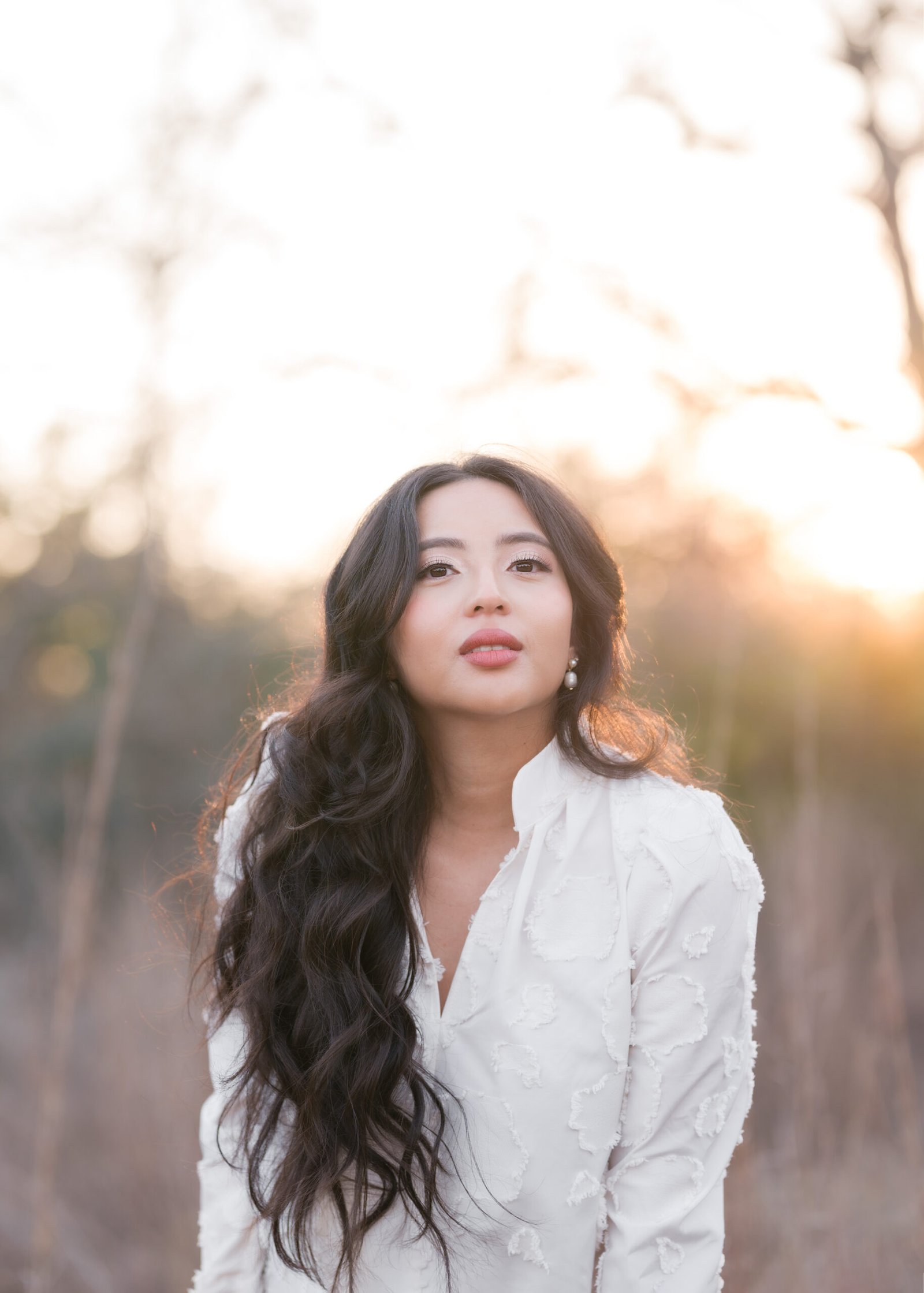 Teresa Vitela The Legacy - elegant woman celebrating birthday in white flowing dress warm golden hour glow Bryan Texas