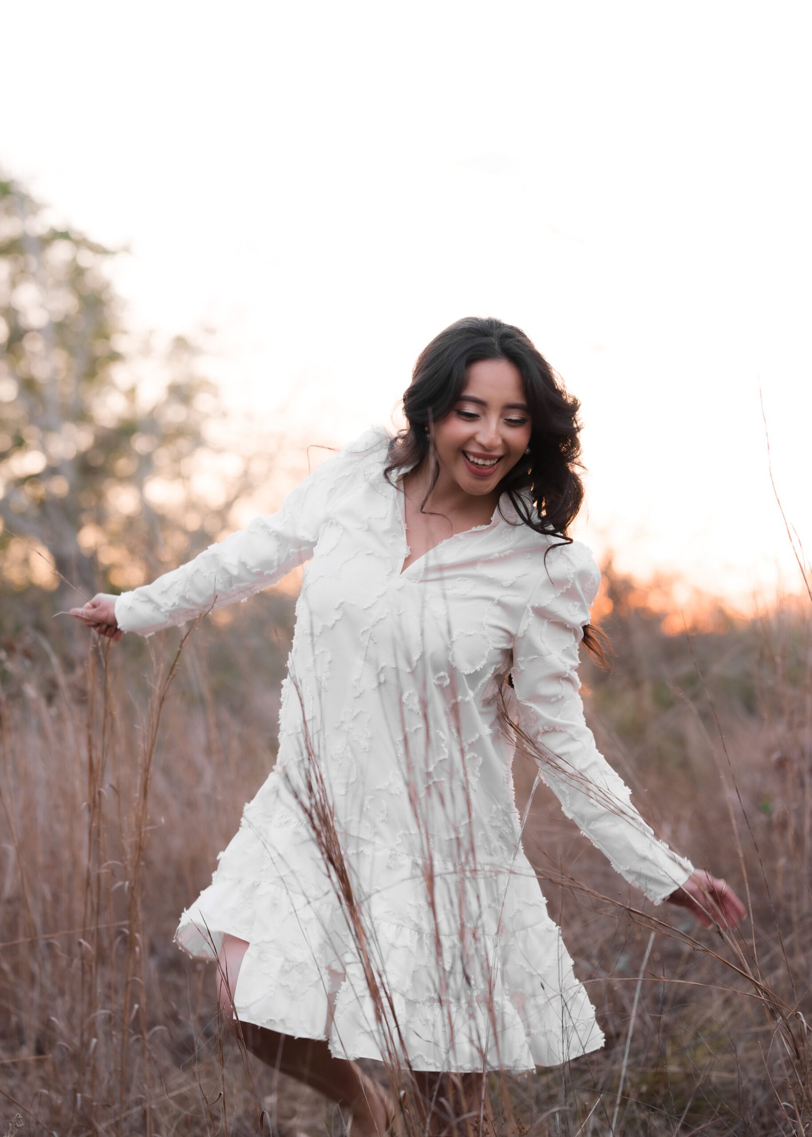 Teresa Vitela The Legacy - woman celebrating birthday with flowers in white dress soft golden sunset light College Station Texas