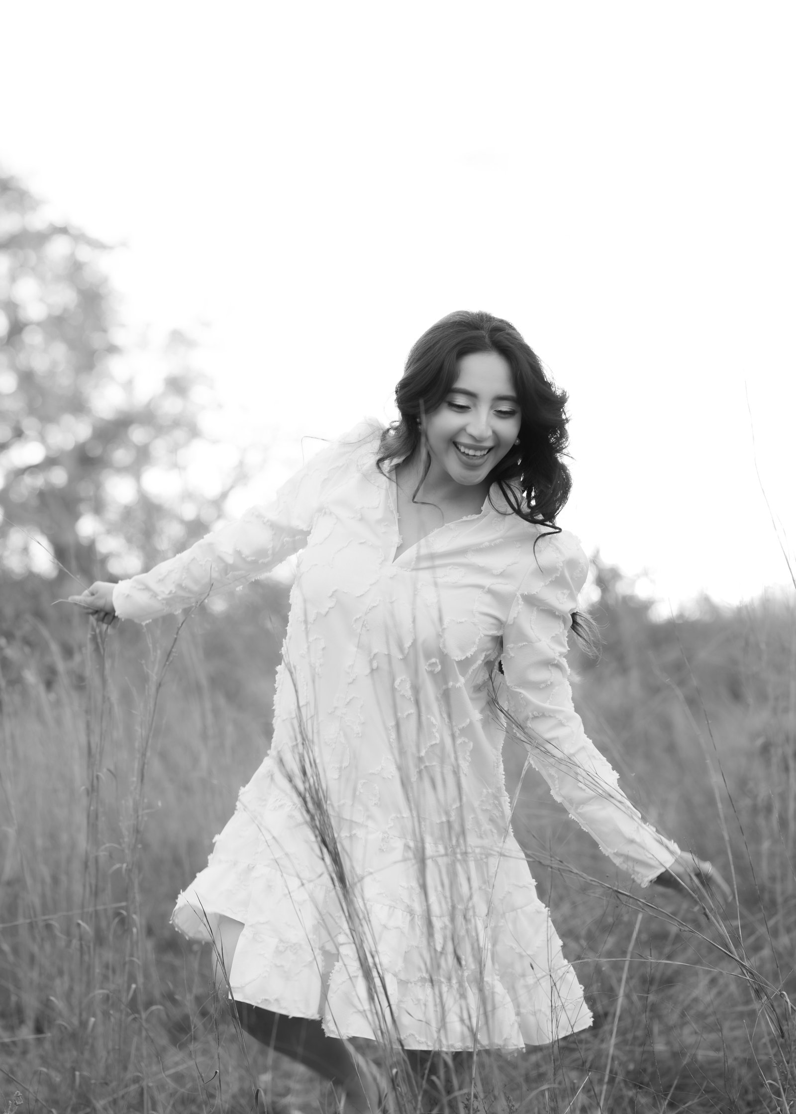 Teresa Vitela The Legacy - Black and white portriat. woman celebrating birthday with flowers in white dress soft golden sunset light College Station Texas