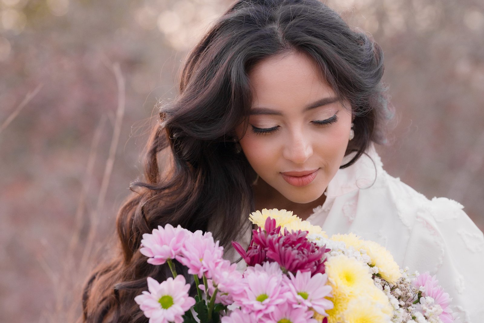 Teresa Vitela The Legacy - elegant woman holding birthday flowers in white dress during golden hour outdoor portrait session Texas