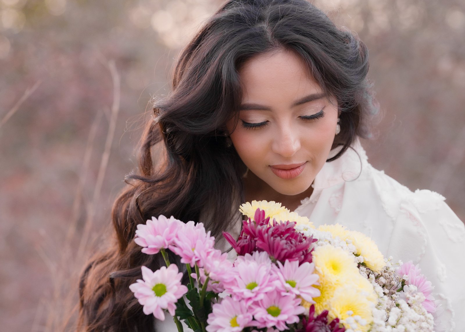 Teresa Vitela The Legacy - elegant woman holding birthday flowers in white dress during golden hour outdoor portrait session Texas