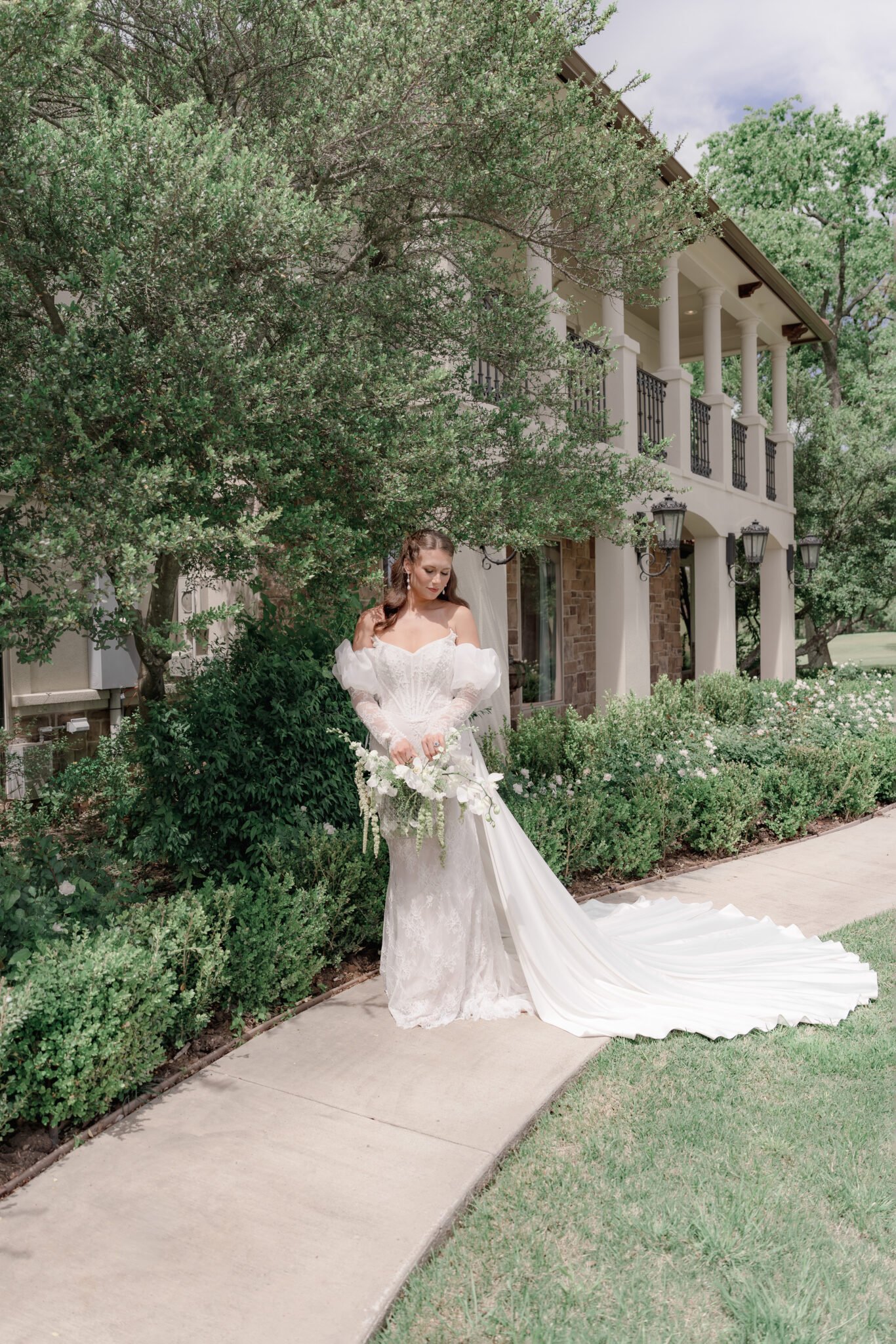 A bride walking through a garden showing the beautiful flow and train of her wedding dress.